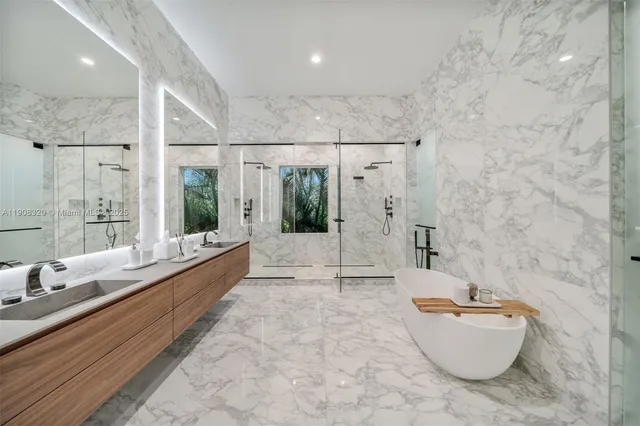 a bathroom with a tub a sink and mirror