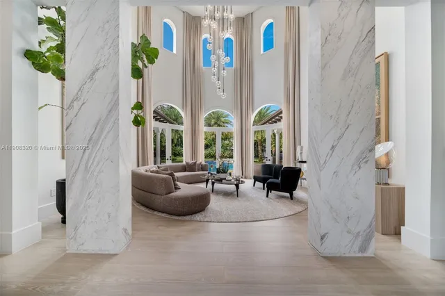 a living room with patio furniture and a potted plant
