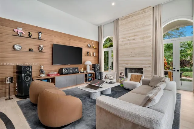 a living room with furniture a fireplace and a flat screen tv