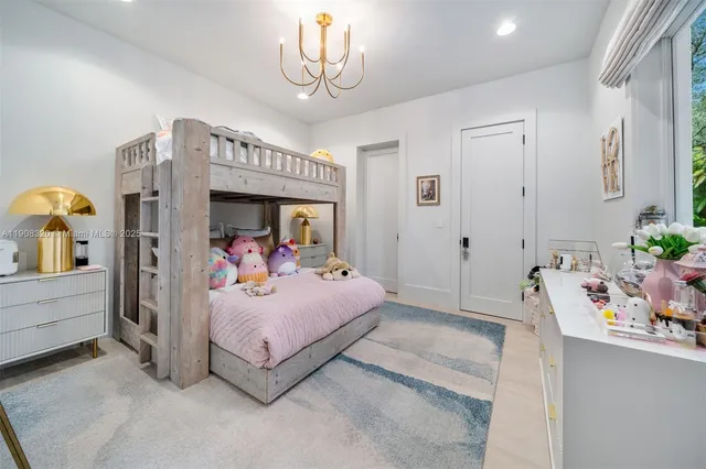 a bedroom with a bed and a chandelier