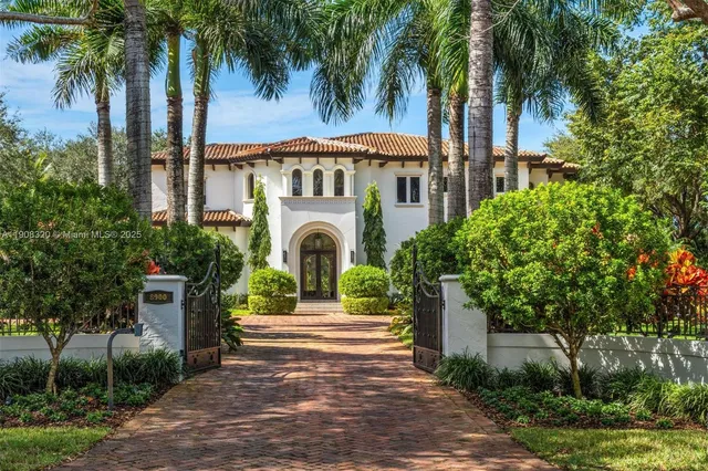 a view of house and sign board with palm trees