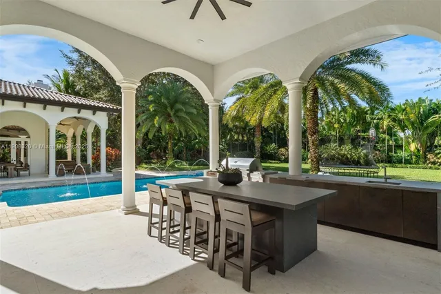 a view of swimming pool with outdoor seating and plants