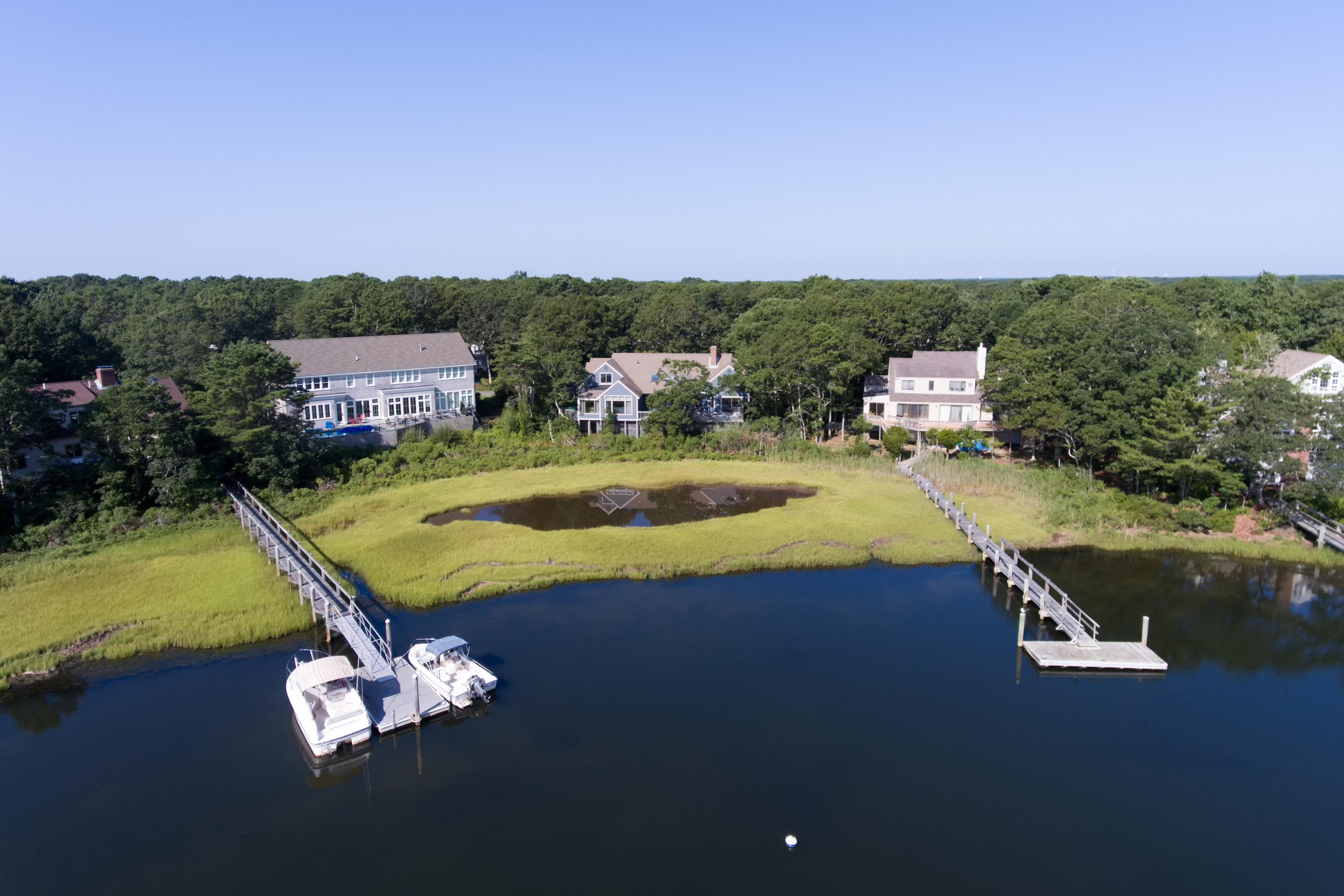 107 Tide Run Mashpee, MA 02649 - Photo 4 of 35 a view of a swimming pool with a yard