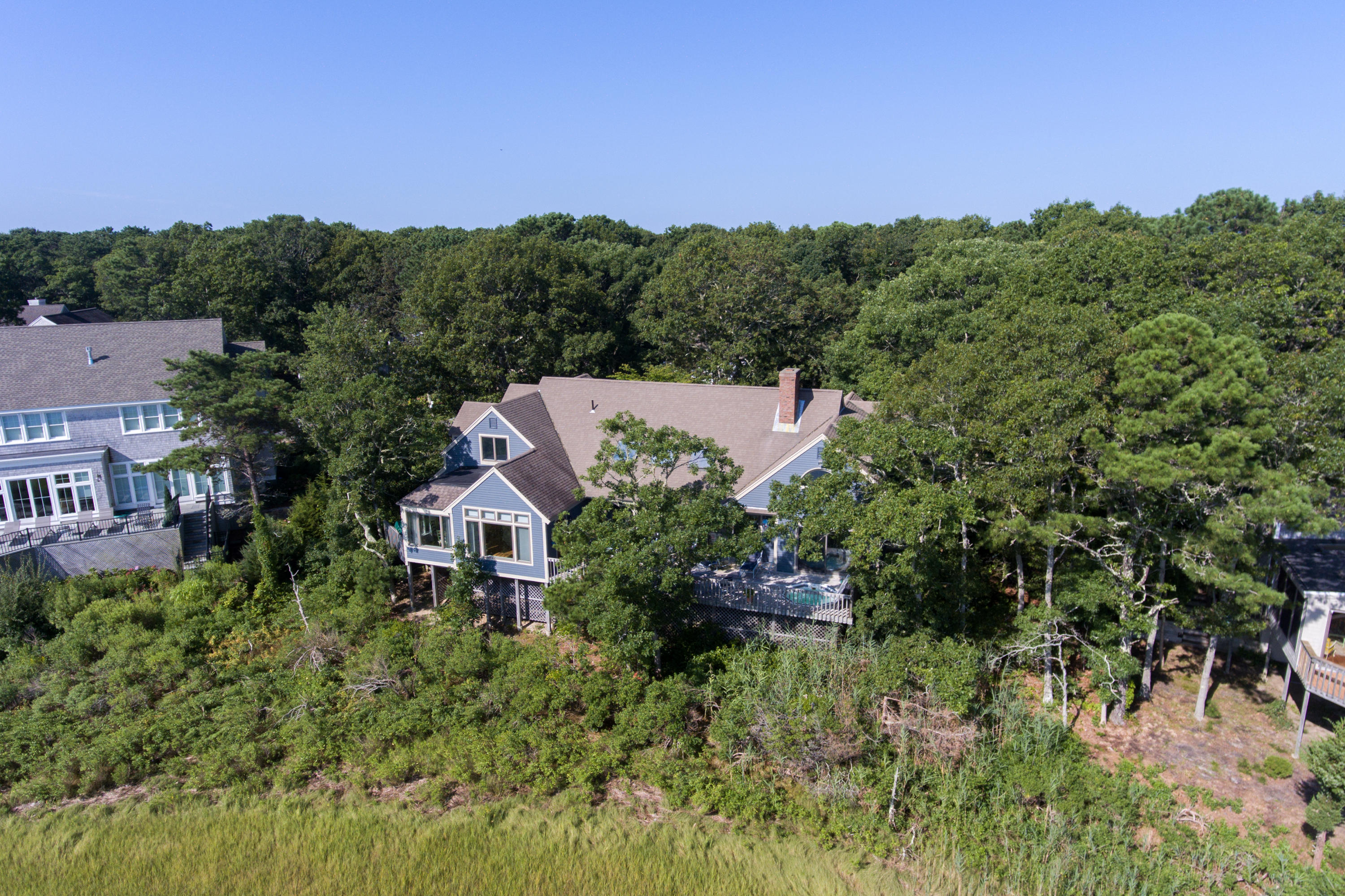 107 Tide Run Mashpee, MA 02649 - Photo 5 of 35 an aerial view of a house with yard and trees in the background