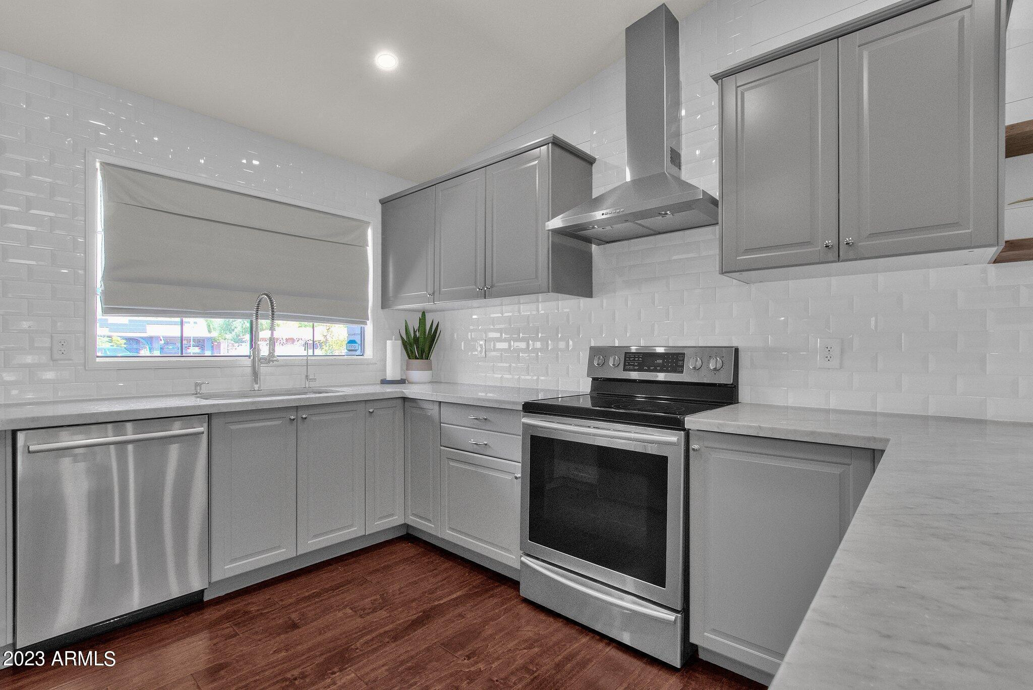 6867 East Phelps Road Scottsdale, AZ 85254 - Photo 13 of 20 a kitchen with granite countertop a stove and a sink