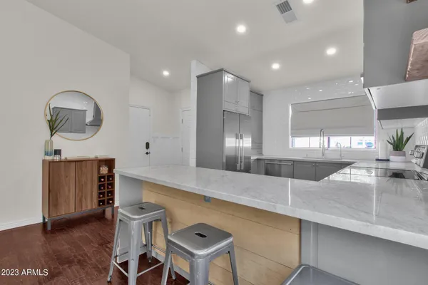 a large kitchen with a table and chairs