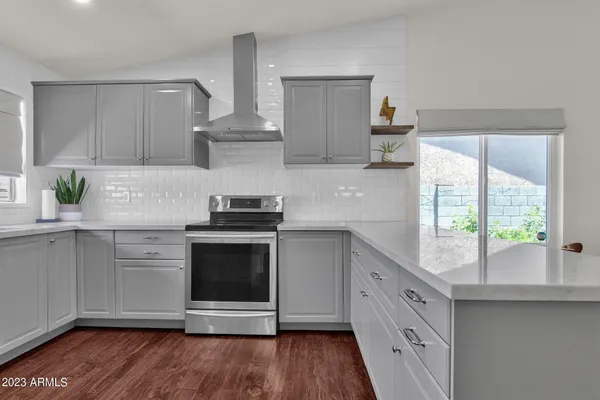 a kitchen with stainless steel appliances a stove sink and cabinets