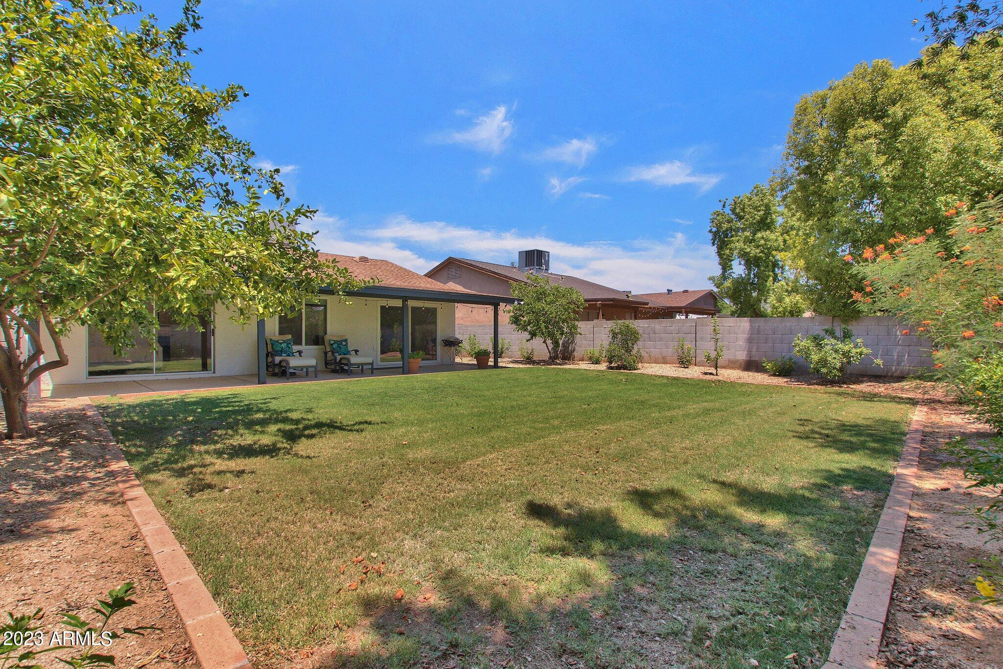 6867 East Phelps Road Scottsdale, AZ 85254 - Photo 3 of 20 a front view of a house with a yard