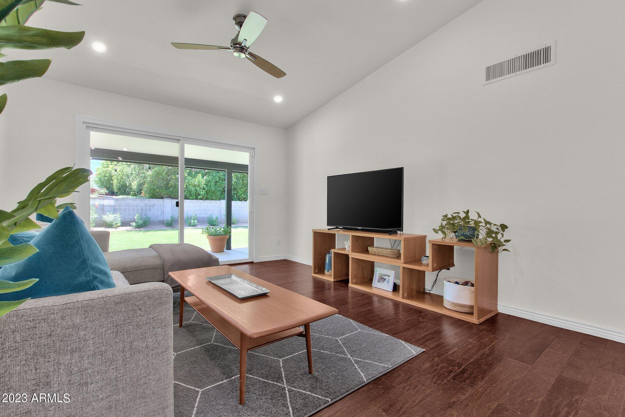 6867 East Phelps Road Scottsdale, AZ 85254 - Photo 6 of 20 a living room with furniture a flat screen tv and a large window