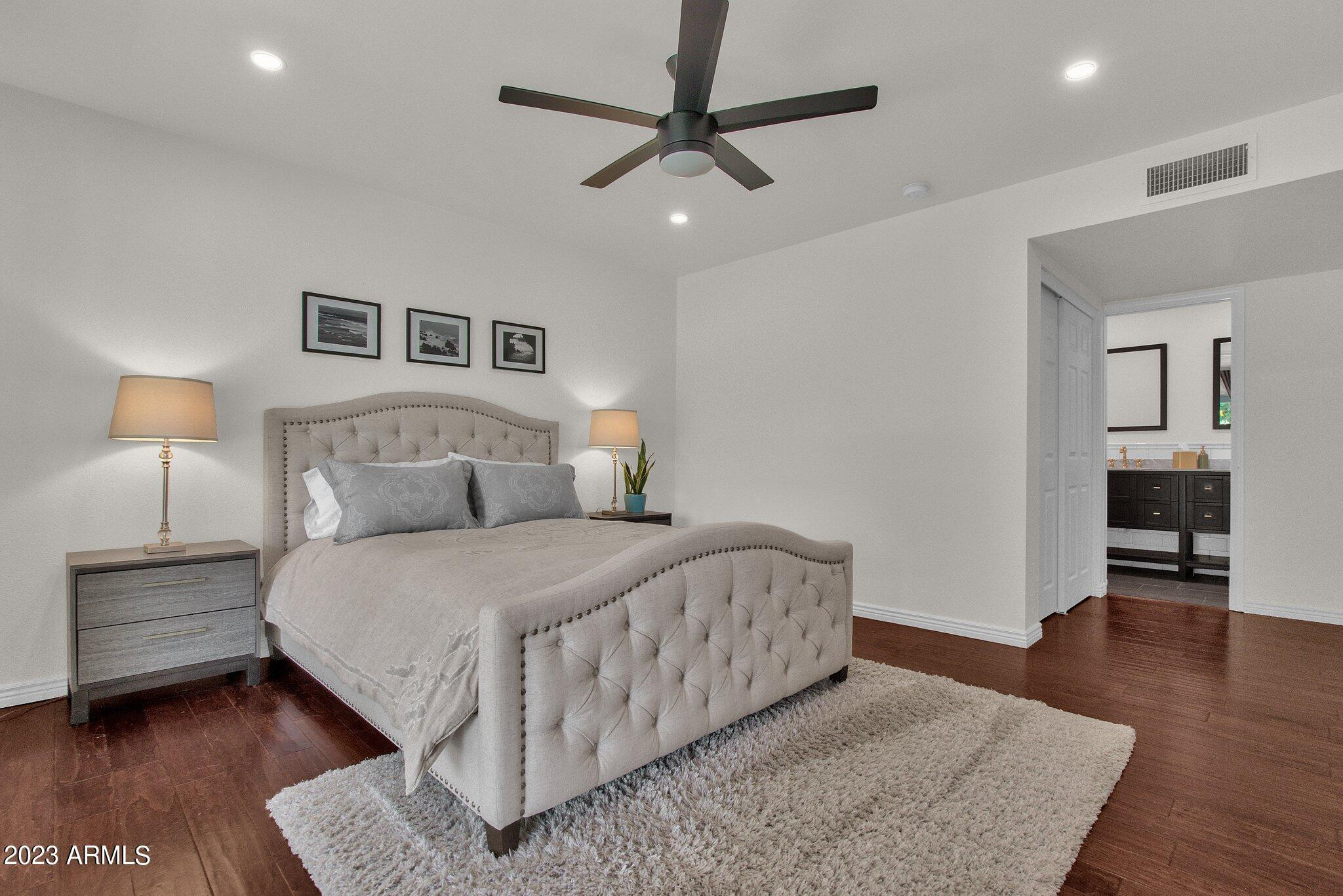 6867 East Phelps Road Scottsdale, AZ 85254 - Photo 7 of 20 a bedroom with a large bed and a chandelier