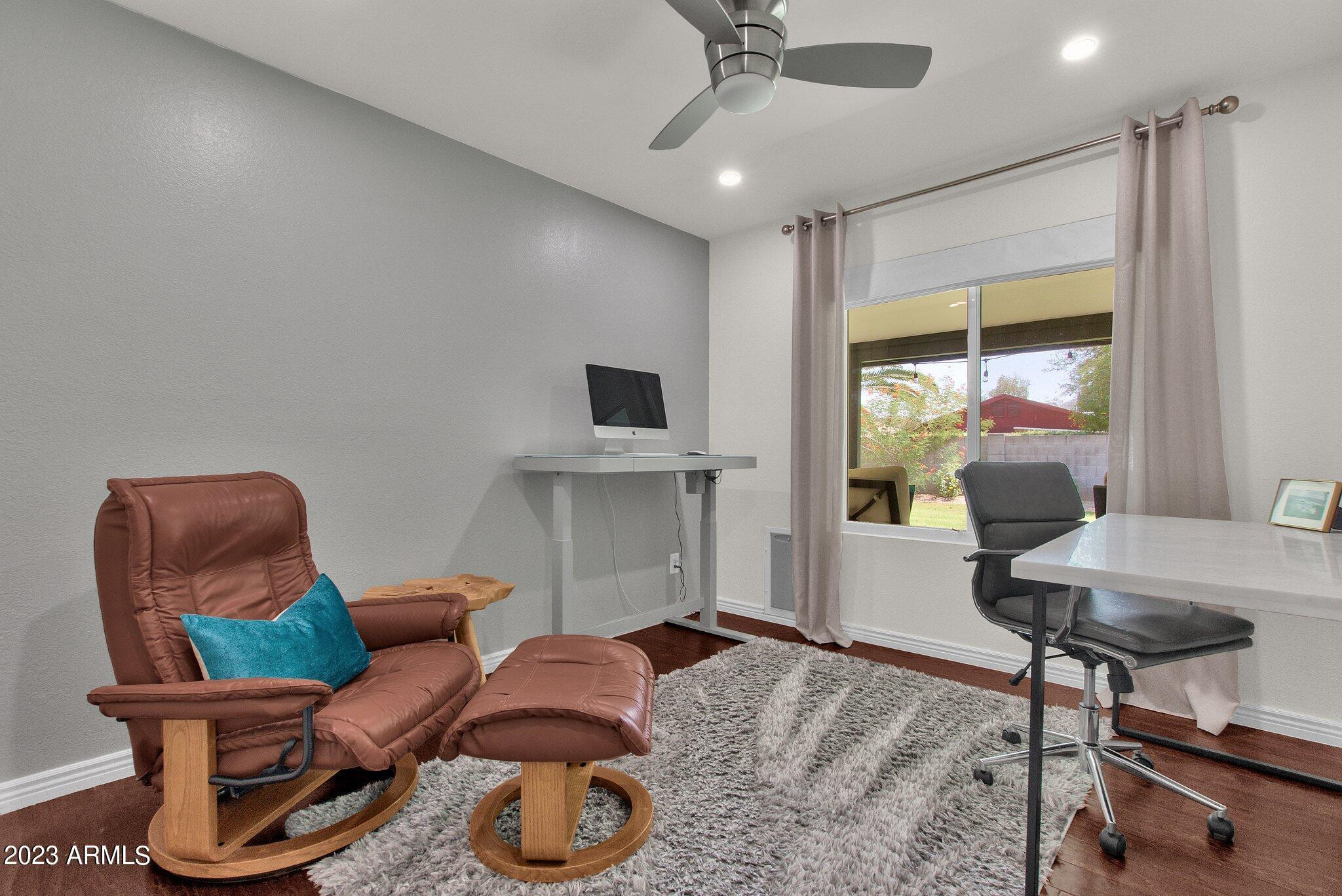 6867 East Phelps Road Scottsdale, AZ 85254 - Photo 10 of 20 a living room with furniture a window and a chandelier