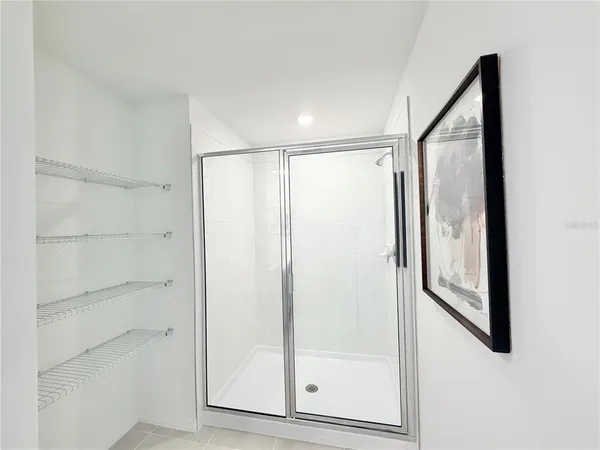 a bathroom with a glass shower door