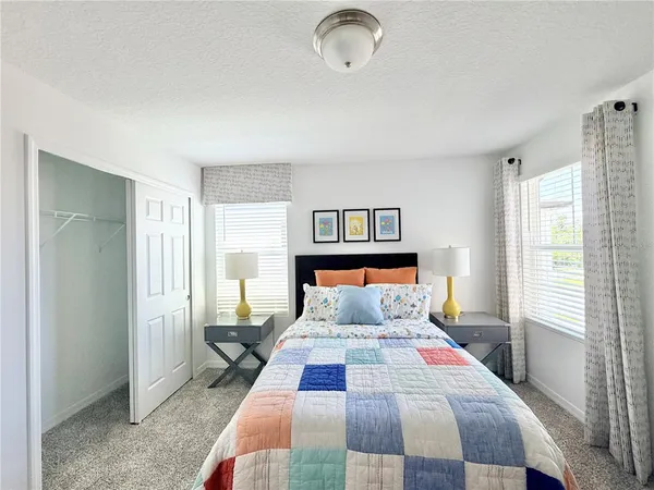 a bedroom with a large bed and a window