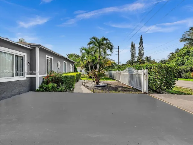 a view of a street with a house in the background