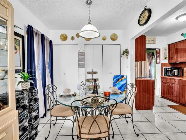 a view of a dining room with furniture wooden floor and chandelier
