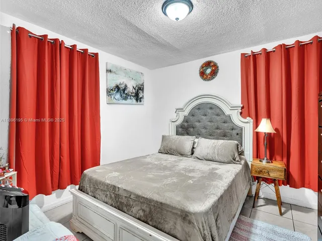 a bedroom with bed and a window