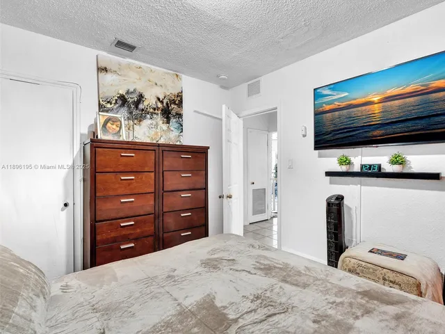 a bedroom with a bed and a television