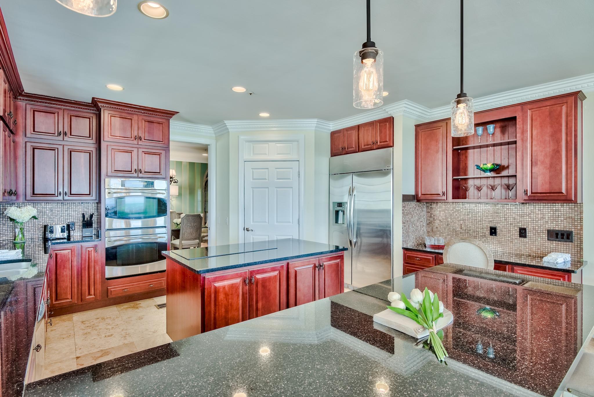 114 Sandprint Circle Destin, FL 32541 - Photo 13 of 57 a kitchen with stainless steel appliances kitchen island granite countertop a stove refrigerator and cabinets