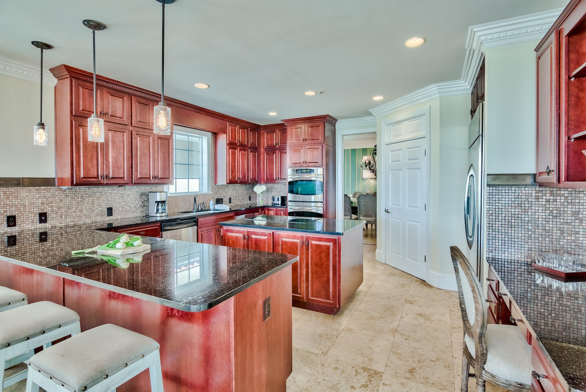 114 Sandprint Circle Destin, FL 32541 - Photo 14 of 57 a kitchen with stainless steel appliances granite countertop a sink and a refrigerator