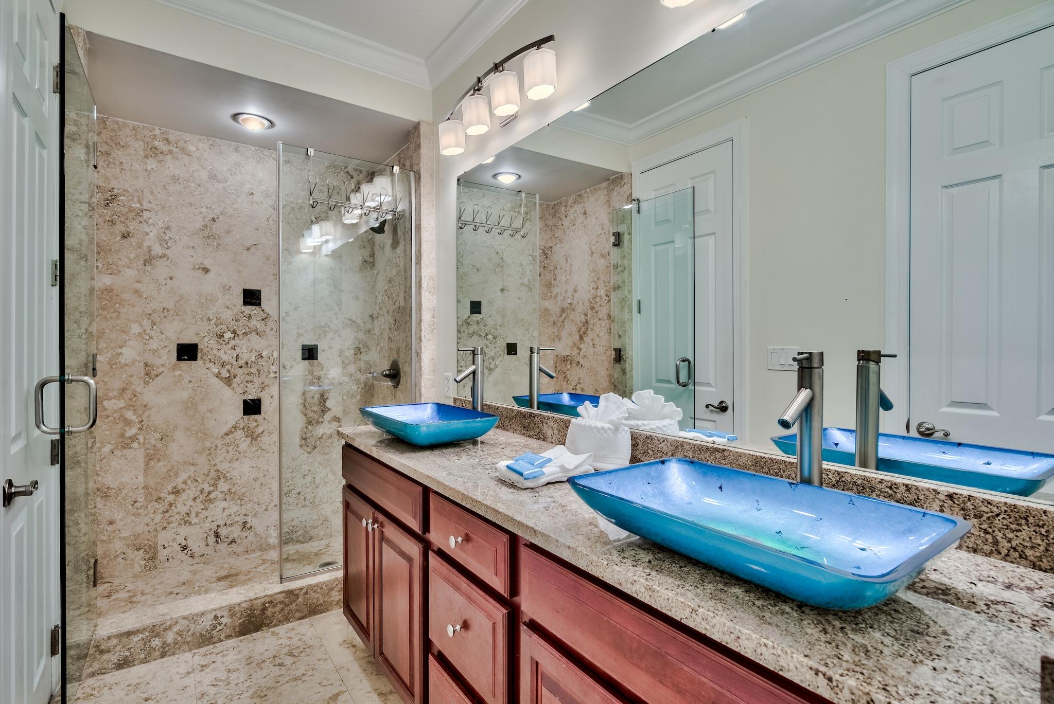 114 Sandprint Circle Destin, FL 32541 - Photo 40 of 57 a bathroom with a granite countertop sink a mirror and a shower