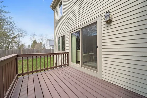 a view of a wooden deck with a yard