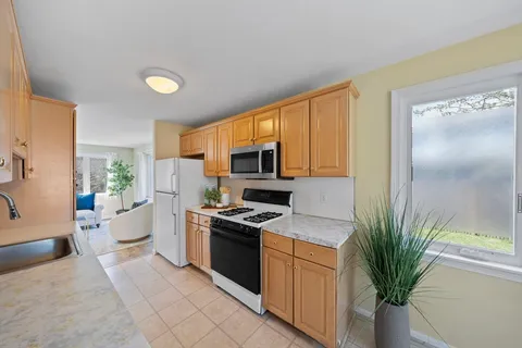 a kitchen with stainless steel appliances a stove a sink and a refrigerator