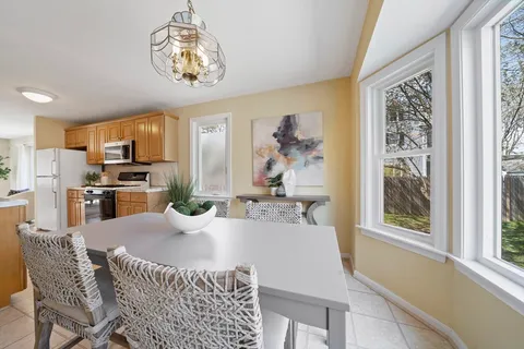 a dining room with furniture a window and kitchen view