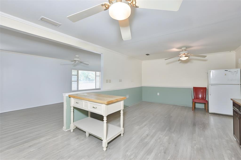 14451 Highland Road Wimauma, FL 33598 - Photo 55 of 80 a room with furniture and a chandelier