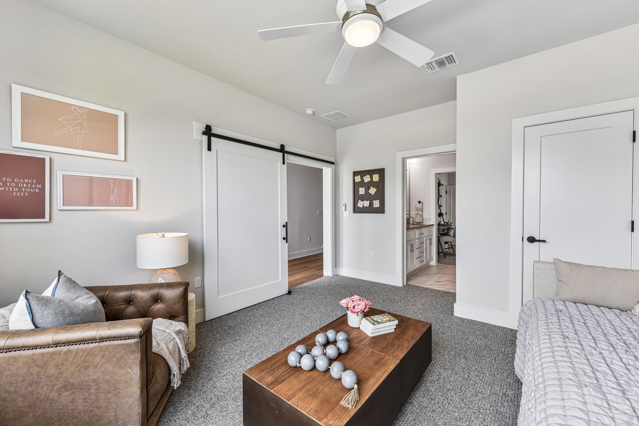 9033 Cattle Baron Path Austin, TX 78747 - Photo 16 of 40 A versatile living area with a sliding barn door leading to an adjoining space.