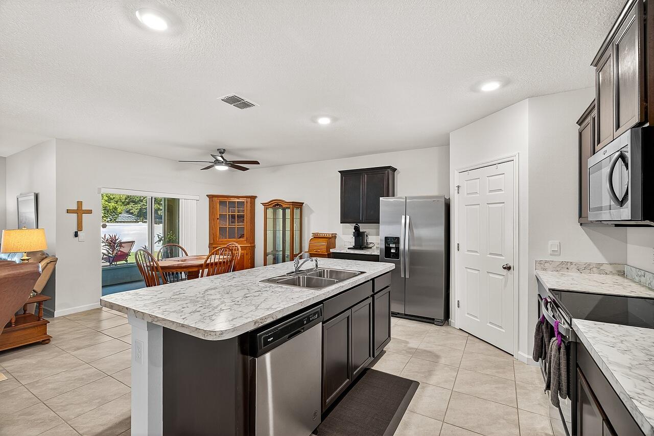 105 Cardinal Drive Sebastian, FL 32958 - Photo 12 of 45 a kitchen with stainless steel appliances granite countertop a sink stove and refrigerator