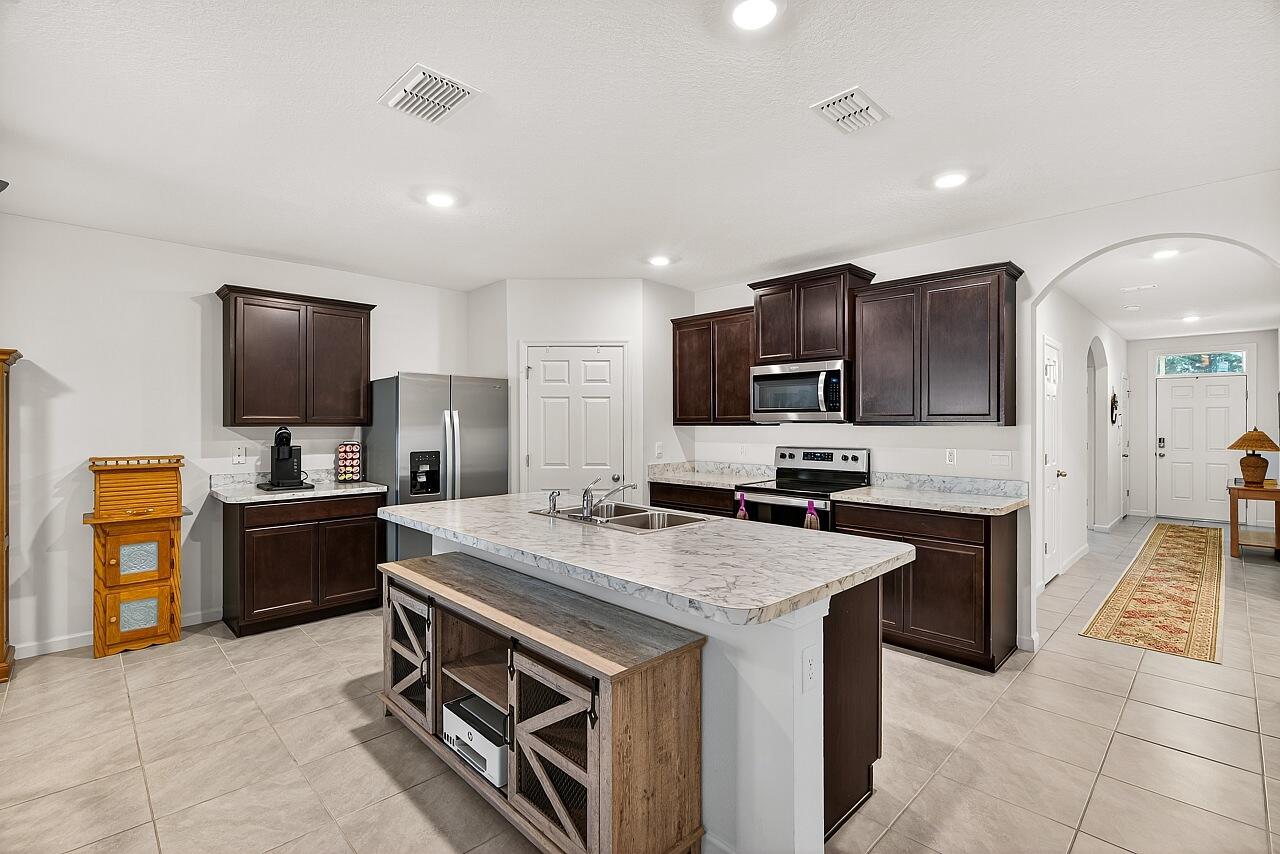 105 Cardinal Drive Sebastian, FL 32958 - Photo 14 of 45 a kitchen with a stove sink and a microwave