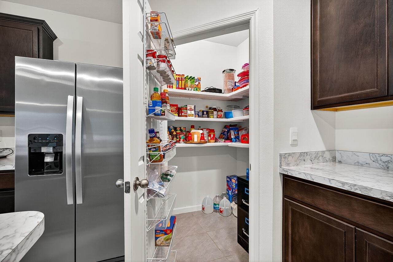 105 Cardinal Drive Sebastian, FL 32958 - Photo 16 of 45 a utility room with refrigerator and washer
