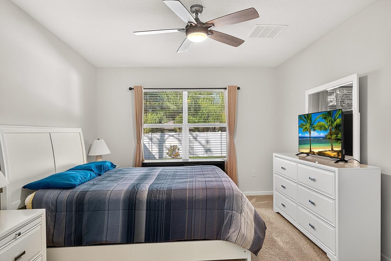 105 Cardinal Drive Sebastian, FL 32958 - Photo 25 of 45 a bedroom with a bed and a flat screen tv