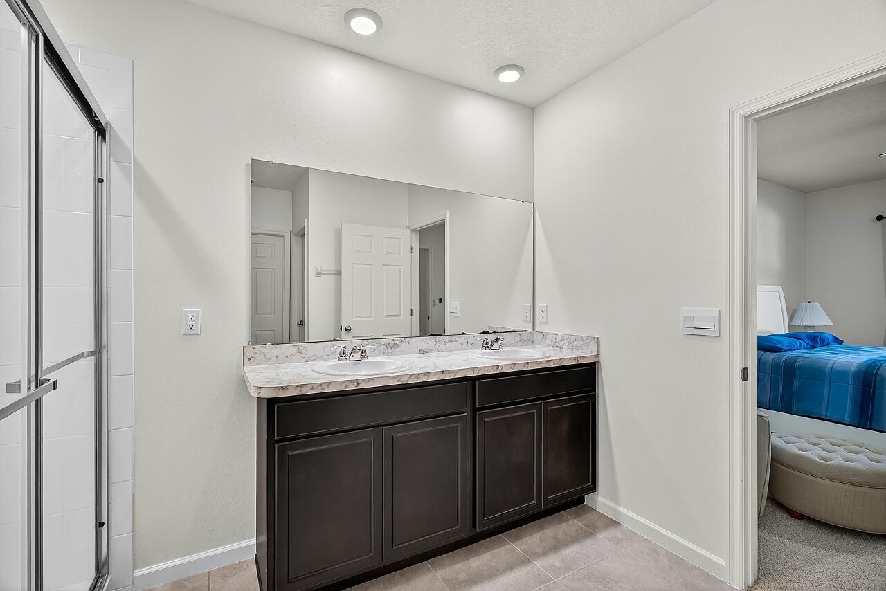 105 Cardinal Drive Sebastian, FL 32958 - Photo 28 of 45 a bathroom with a double vanity sink and mirror