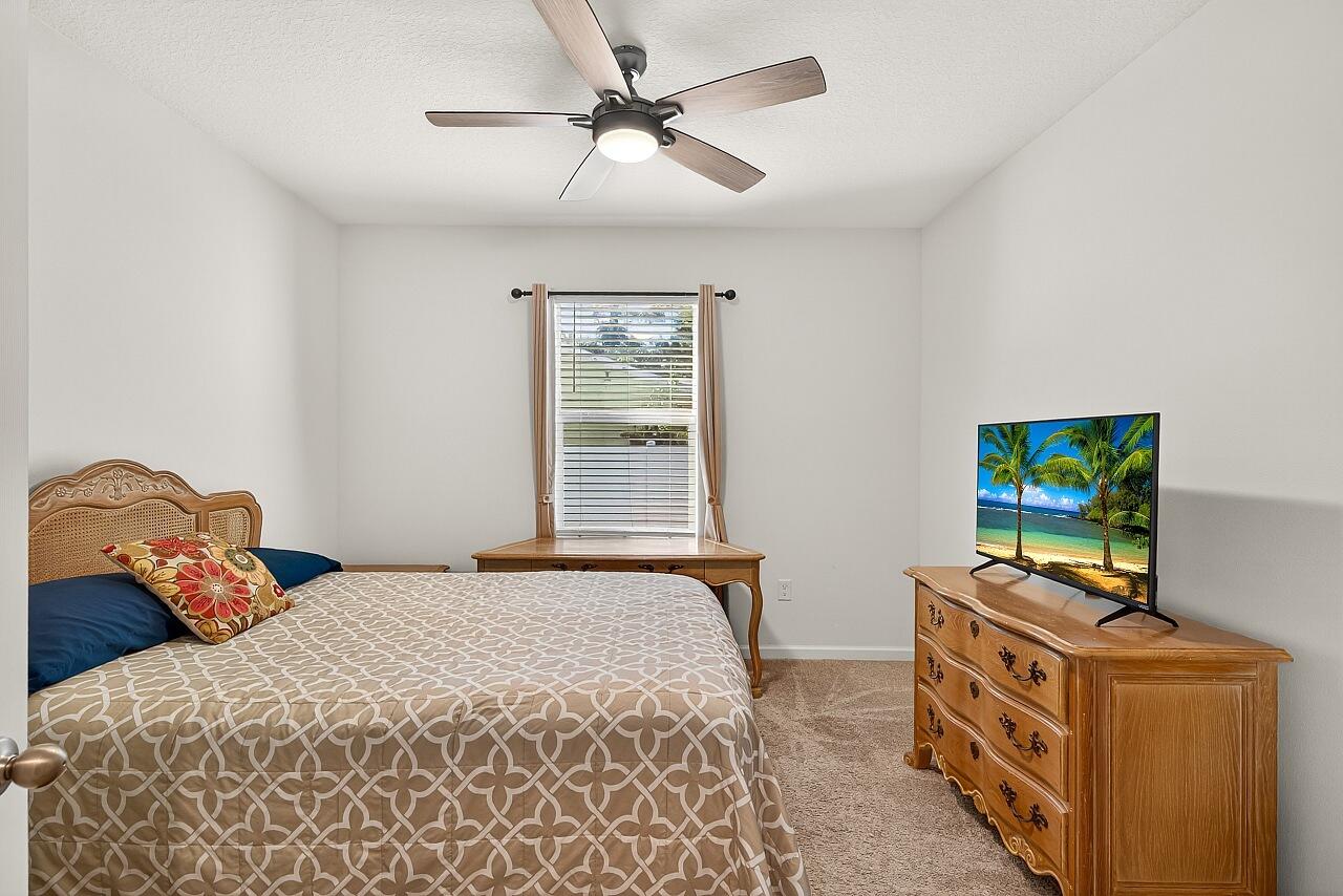 105 Cardinal Drive Sebastian, FL 32958 - Photo 34 of 45 a bedroom with bed and a flat screen tv