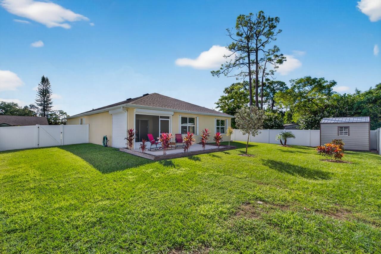 105 Cardinal Drive Sebastian, FL 32958 - Photo 42 of 45 a view of a house with backyard and a tree
