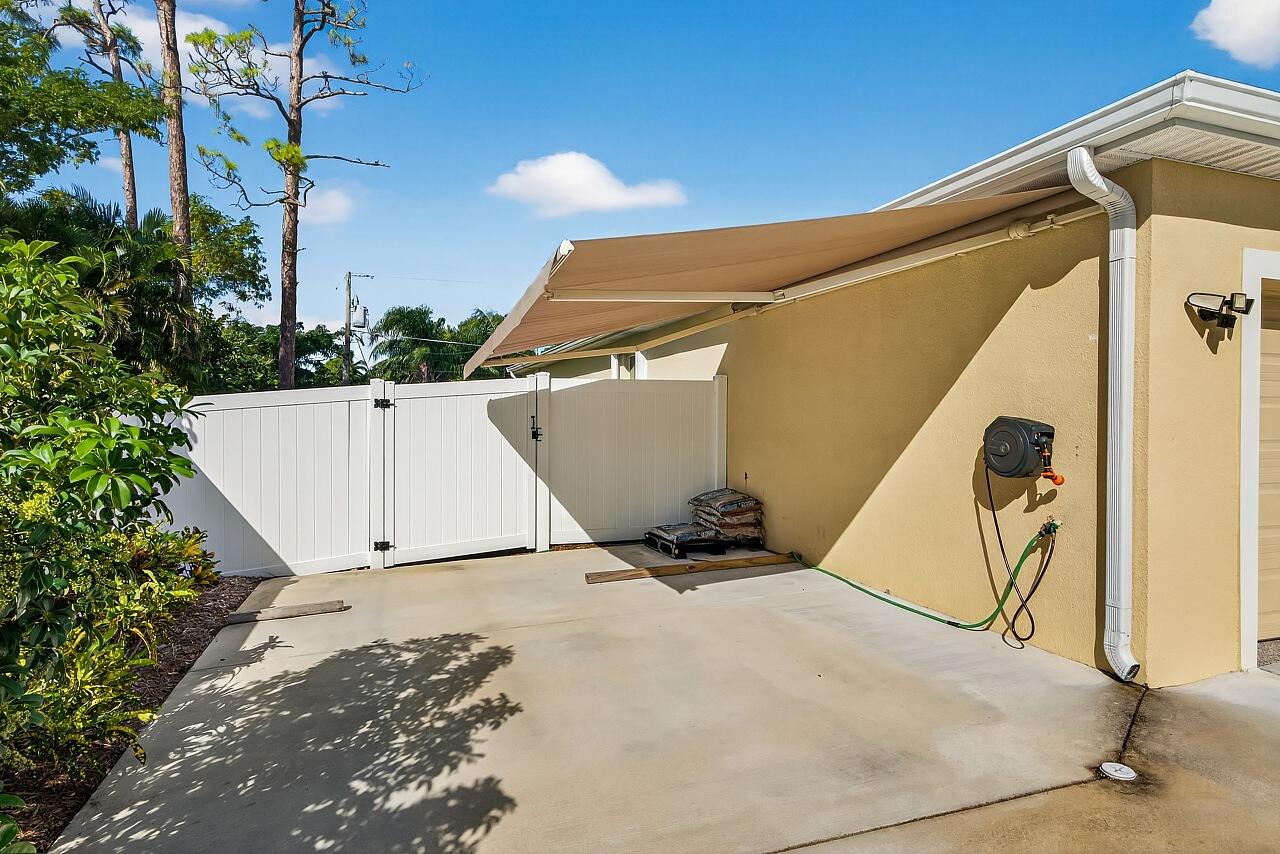 105 Cardinal Drive Sebastian, FL 32958 - Photo 8 of 45 a view of a garage with a tree