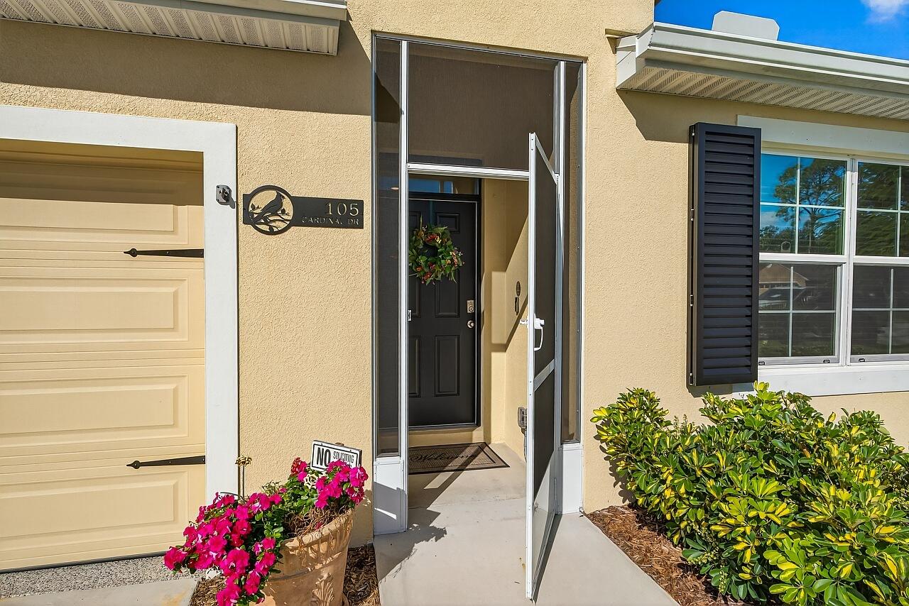 105 Cardinal Drive Sebastian, FL 32958 - Photo 9 of 45 a front view of a house with a potted plant
