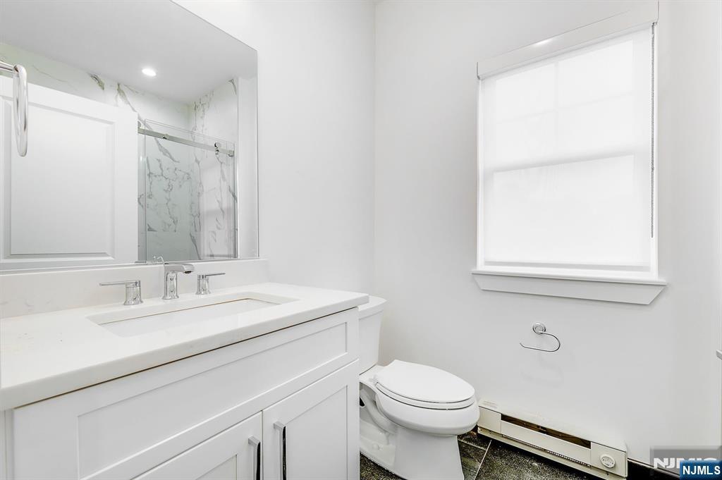 74 Clarendon Place, Unit 202 Hackensack, NJ 07601 - Photo 21 of 33 a bathroom with a sink and a mirror