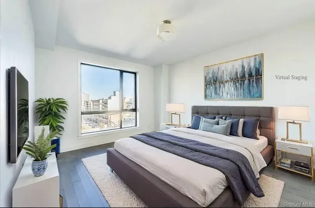 a bedroom with a large bed and a potted plant