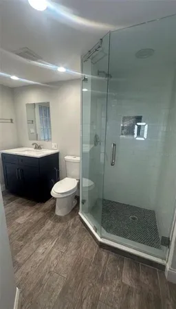 a bathroom with a toilet and a shower