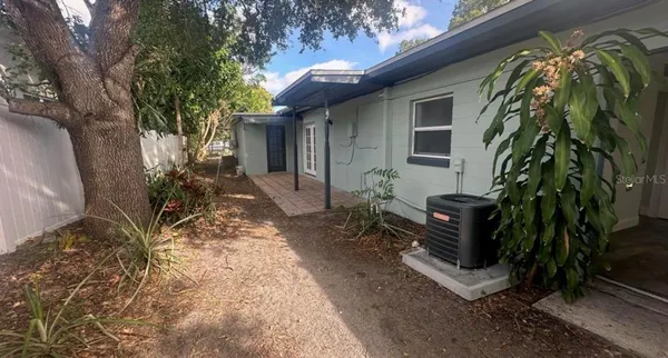 a view of a house with a yard and sitting area