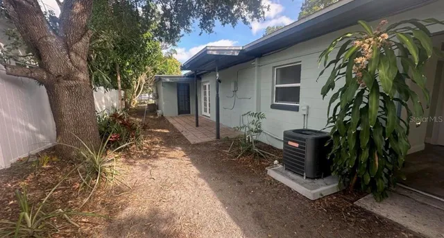 a view of a house with a yard and sitting area