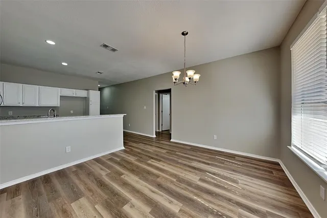 a view of a kitchen with a dishwasher cabinets and a wooden floor