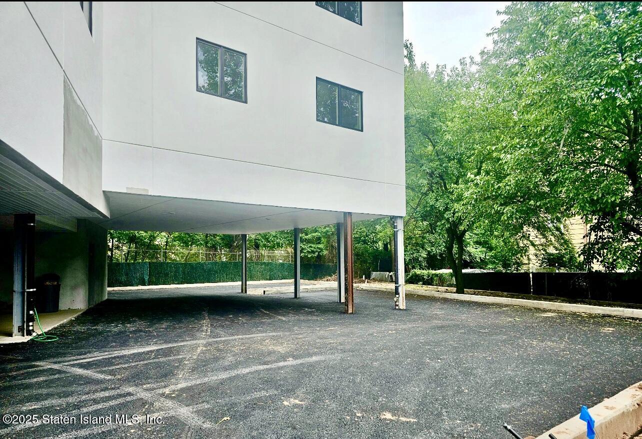3865 Amboy Road, Unit 4D Staten Island, NY 10308 - Photo 28 of 30 a view of a patio with table and chairs and a large tree