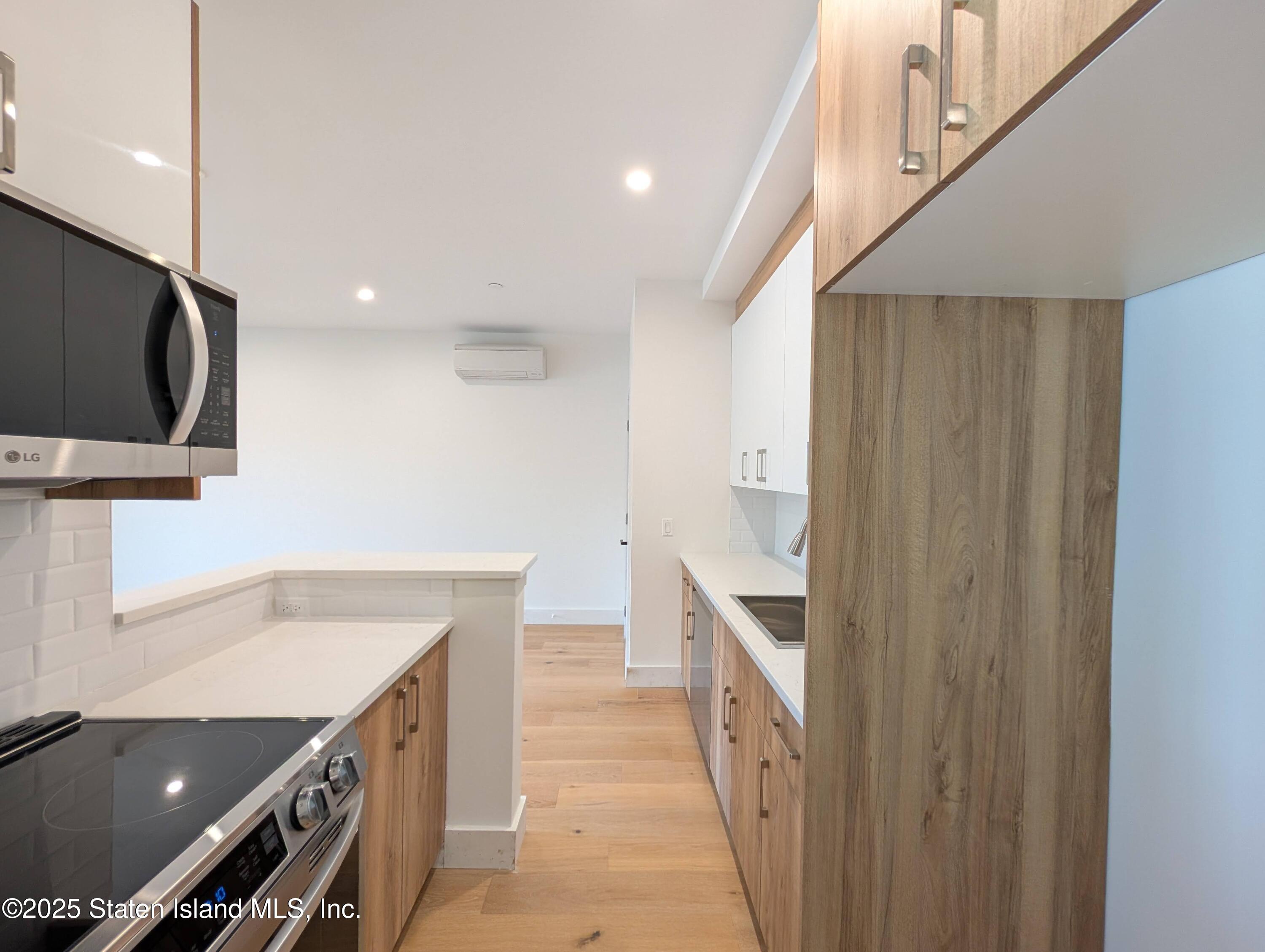 3865 Amboy Road, Unit 4D Staten Island, NY 10308 - Photo 5 of 30 a kitchen with a sink and a refrigerator