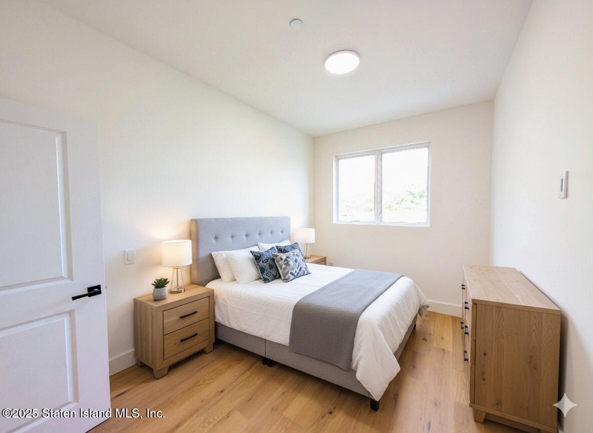 3865 Amboy Road, Unit 4D Staten Island, NY 10308 - Photo 9 of 30 a bedroom with a bed and a couch