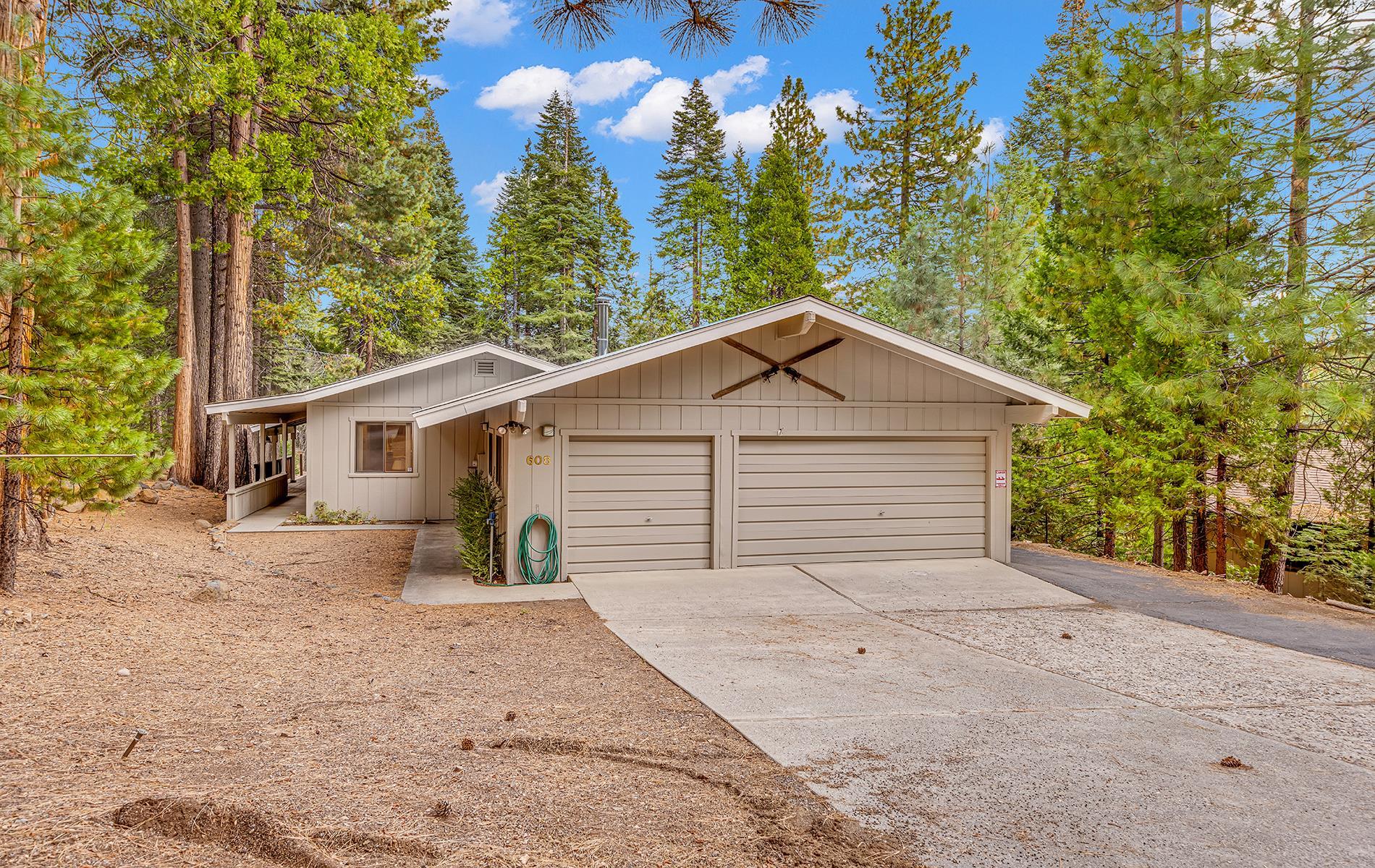 608 East Burnt Cedar Road Lake Almanor, CA 96137 - Photo 1 of 36 a view of a house with a yard and large tree