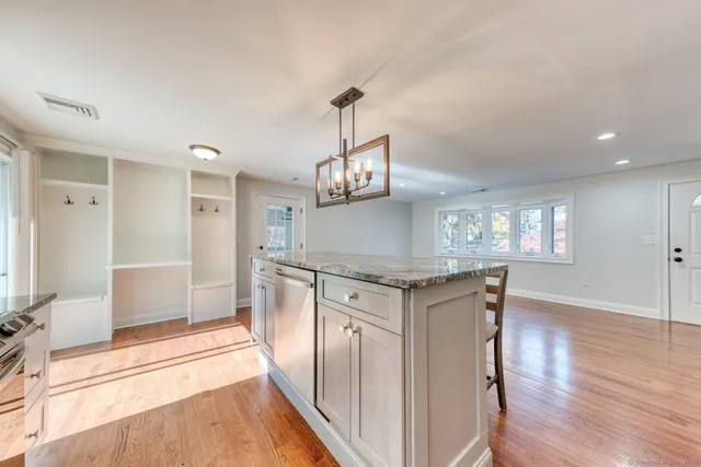 a kitchen with stainless steel appliances granite countertop a stove and a refrigerator