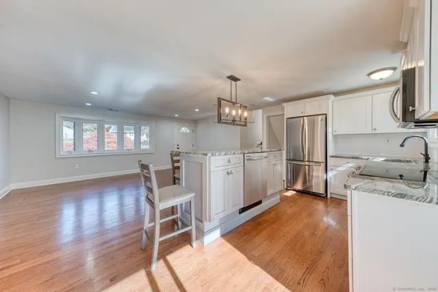 a kitchen with refrigerator cabinets and wooden floor